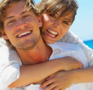 Couple showing off their white tooth colored dental fillings near Grand Rapids.